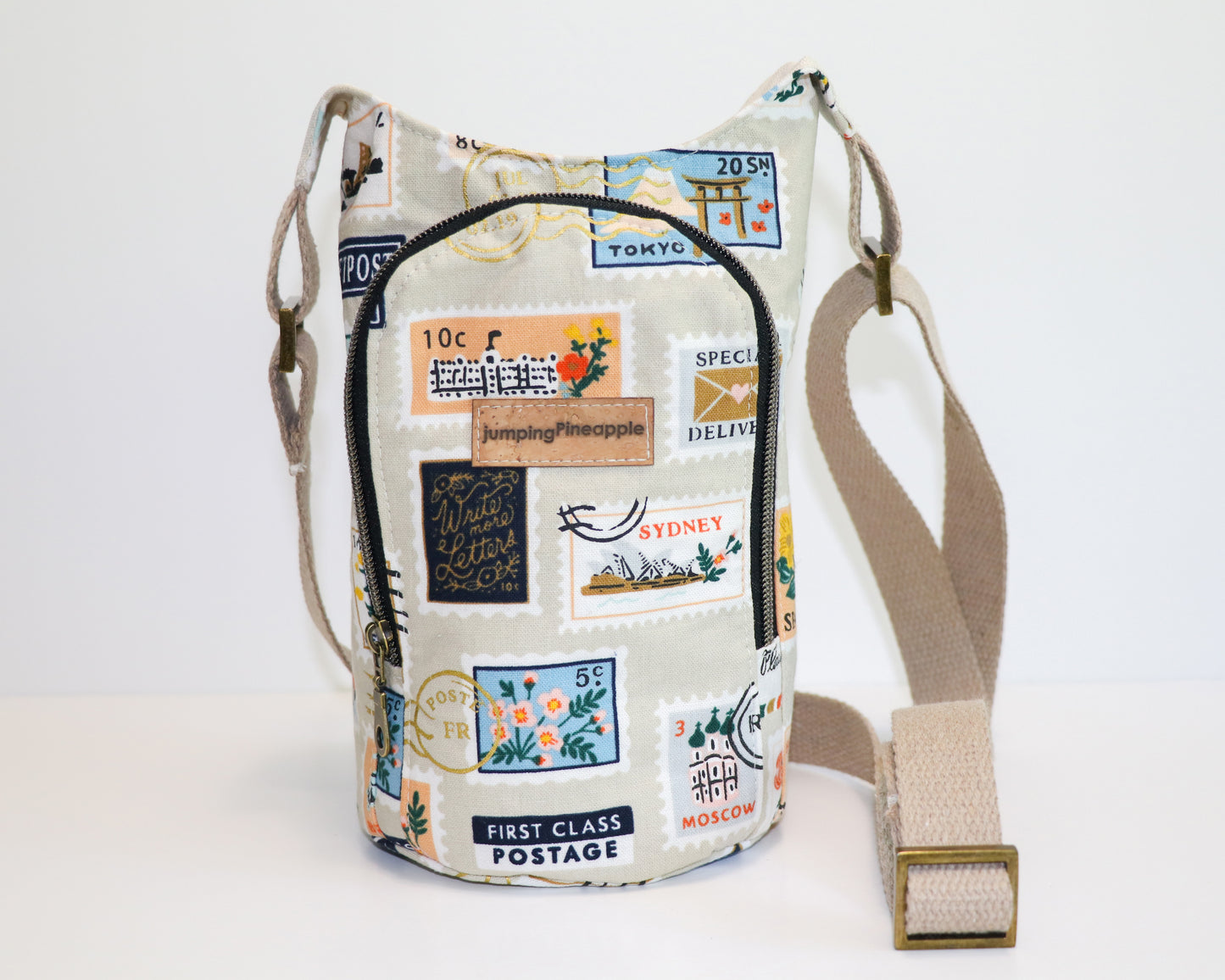 postage stamps print water bottle sling, front view