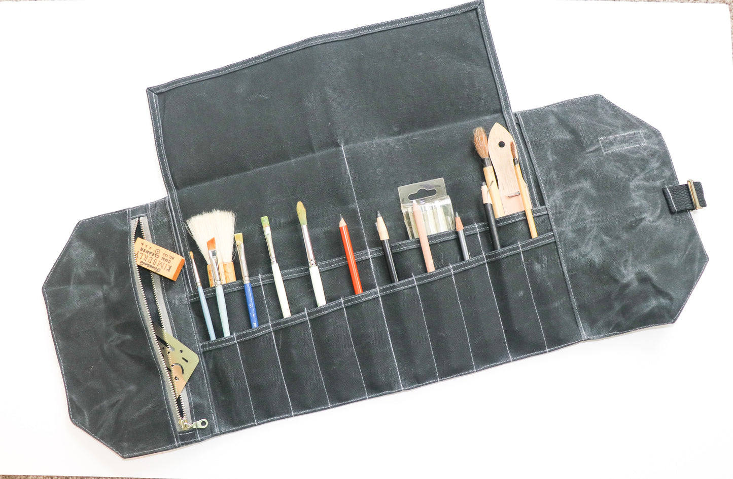 different color of large tan artist roll, inside view with art supplies