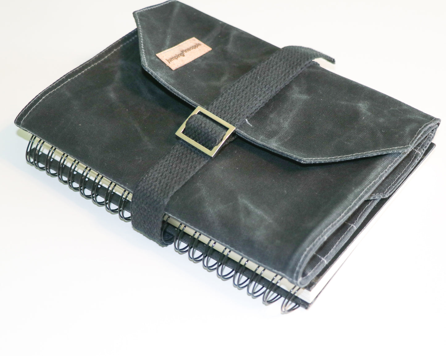 black artist roll, exterior view, strapped to sketch book