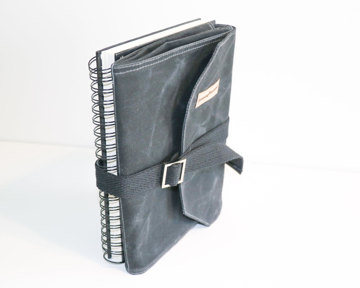 black artist roll, strapped to sketchbook