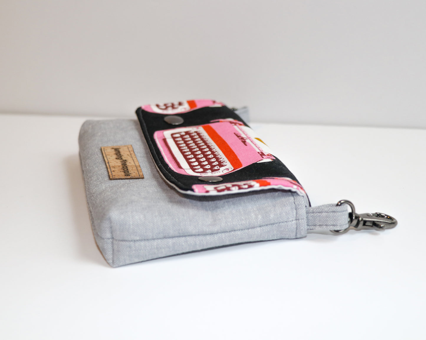 black and pink typewriter belt loop pouch, side view laying flat