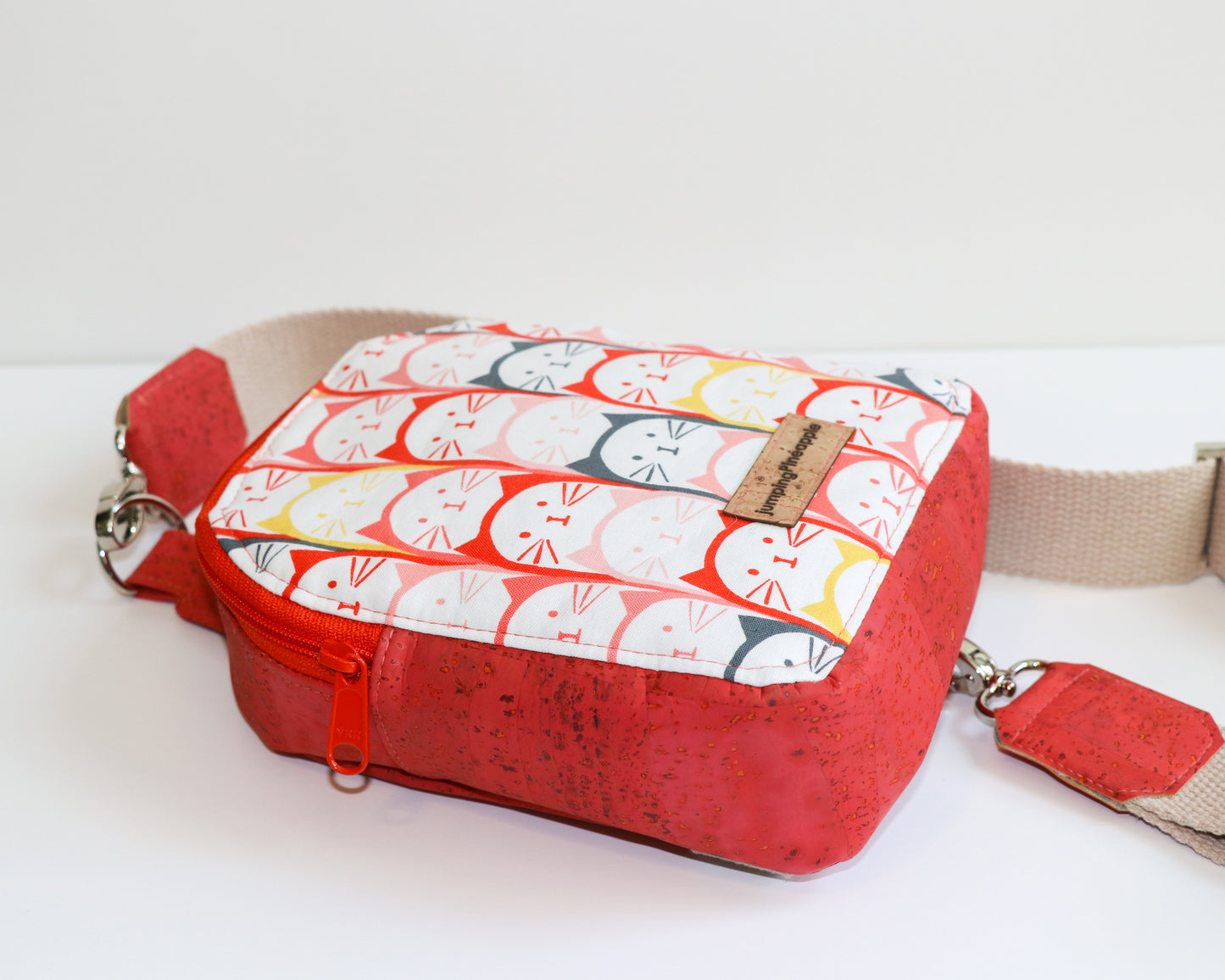 coral cats mini backpack sling, laying flat