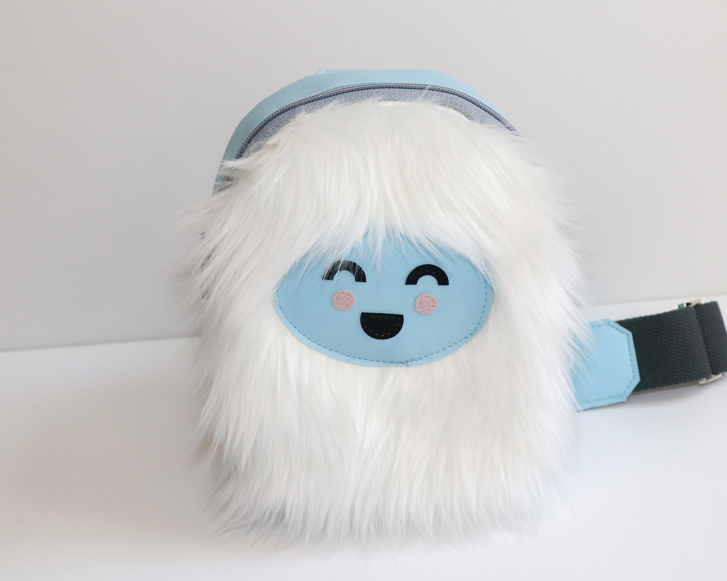white furry Yeti mini backpack sling, front view