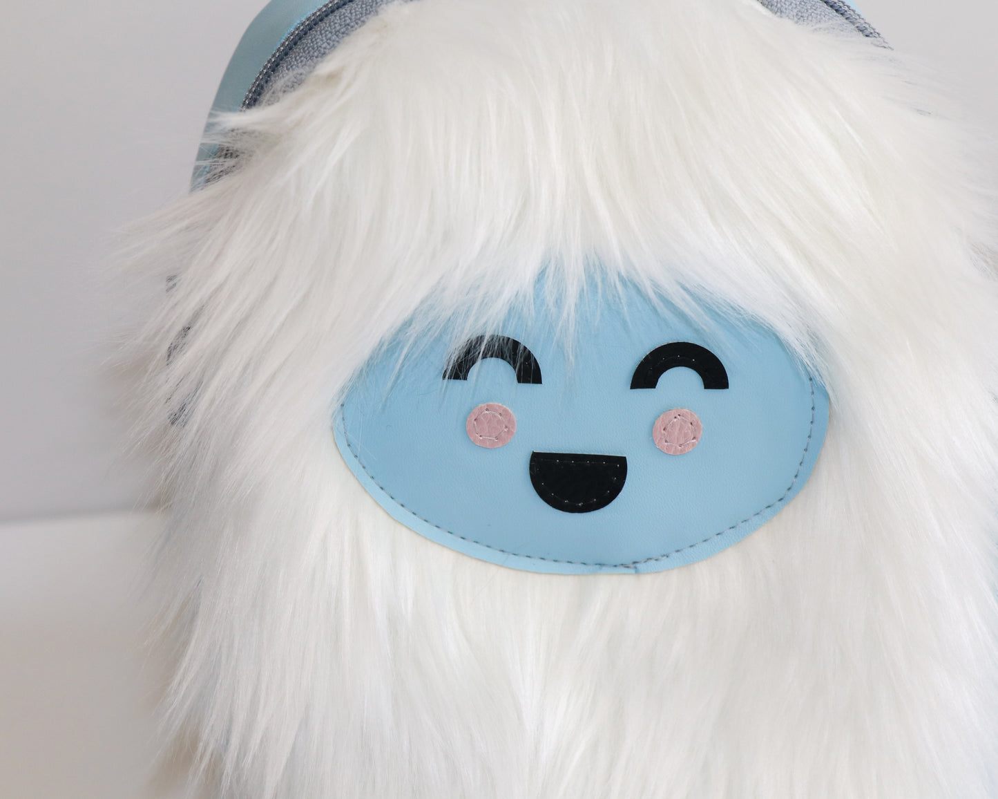 white furry Yeti mini backpack sling, front view