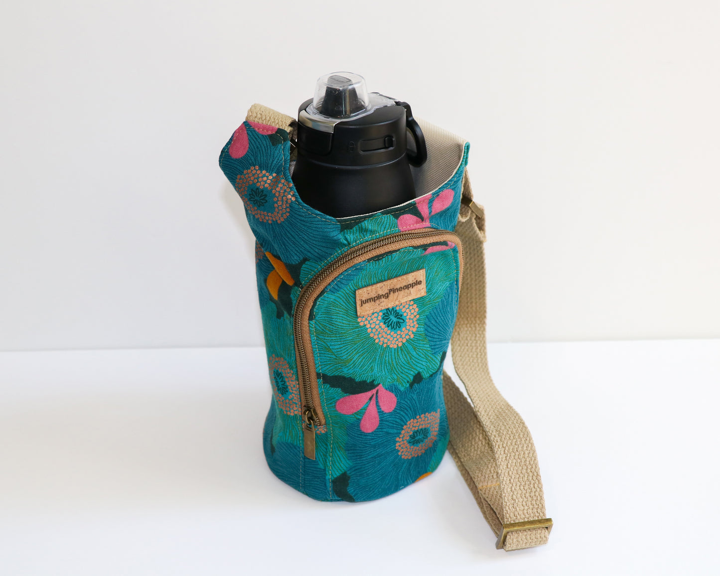 teal and blue floral water bottle sling, side view with water bottle inside