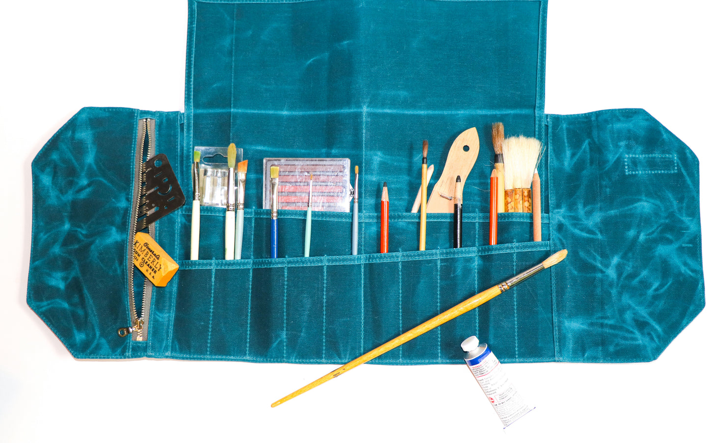 large teal artist roll, inside view with art supplies