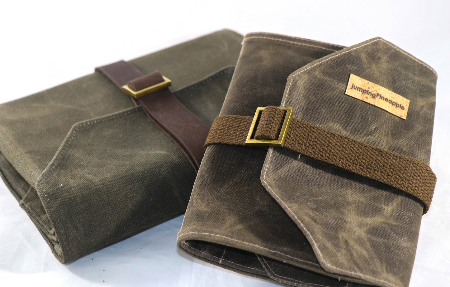 dark brown artist roll with leather strap and cotton strap shown