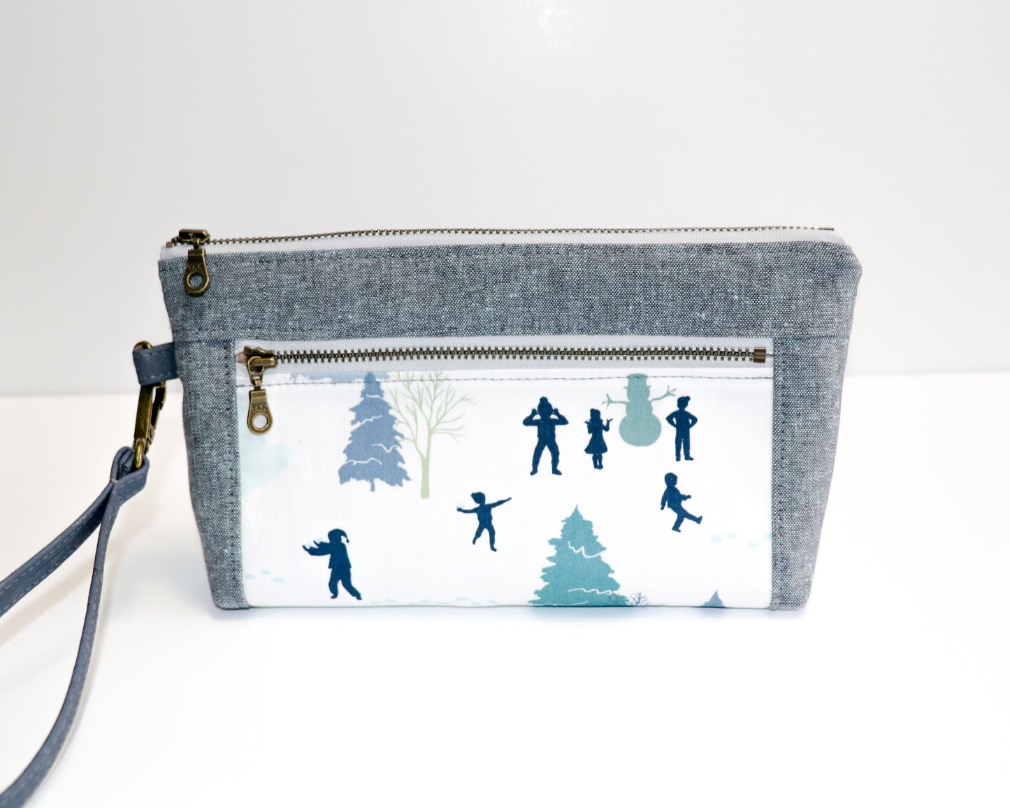 kids playing in the snow and grey/blue linen wristlet