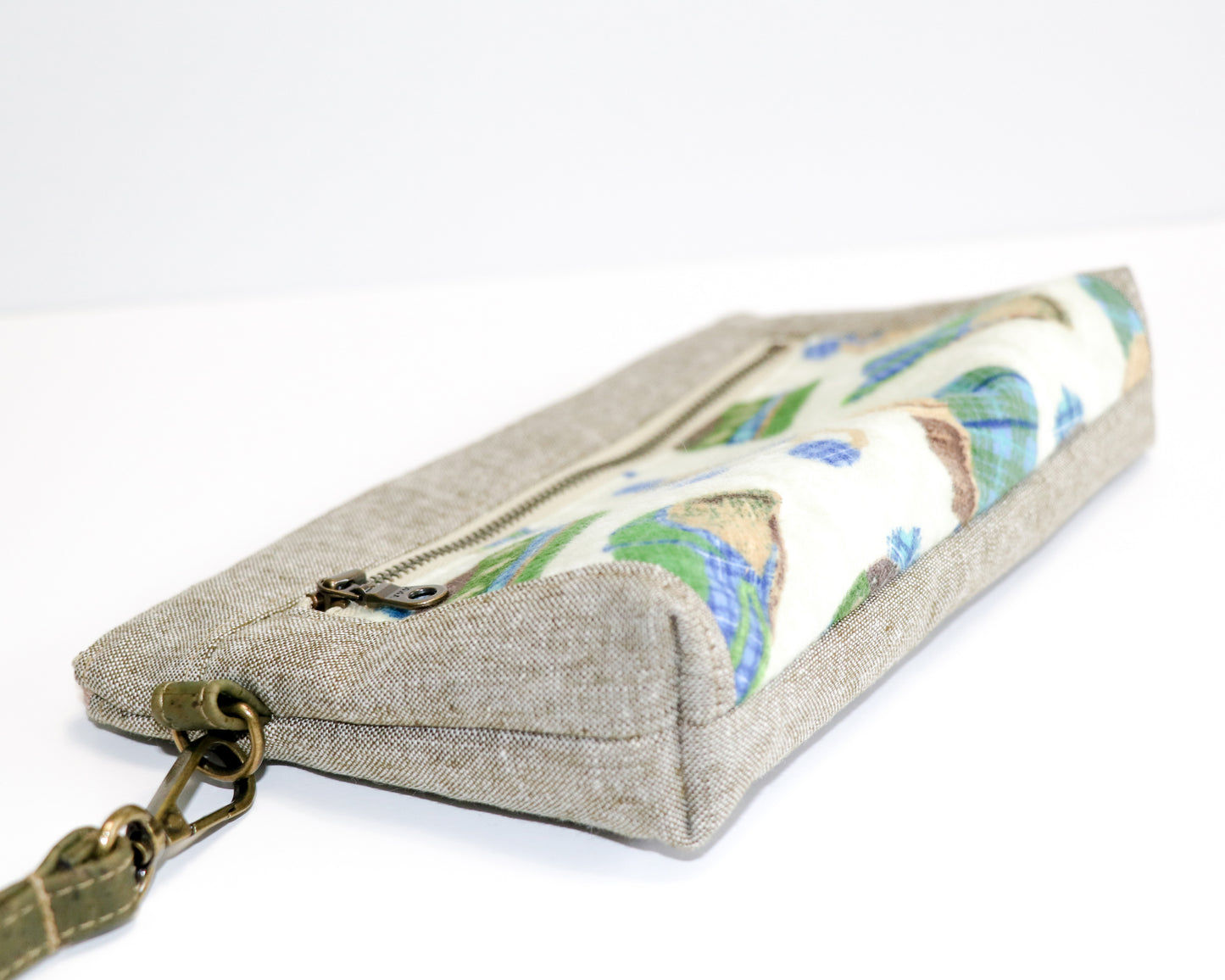 flannel winter hats and olive linen wristlet laid flat