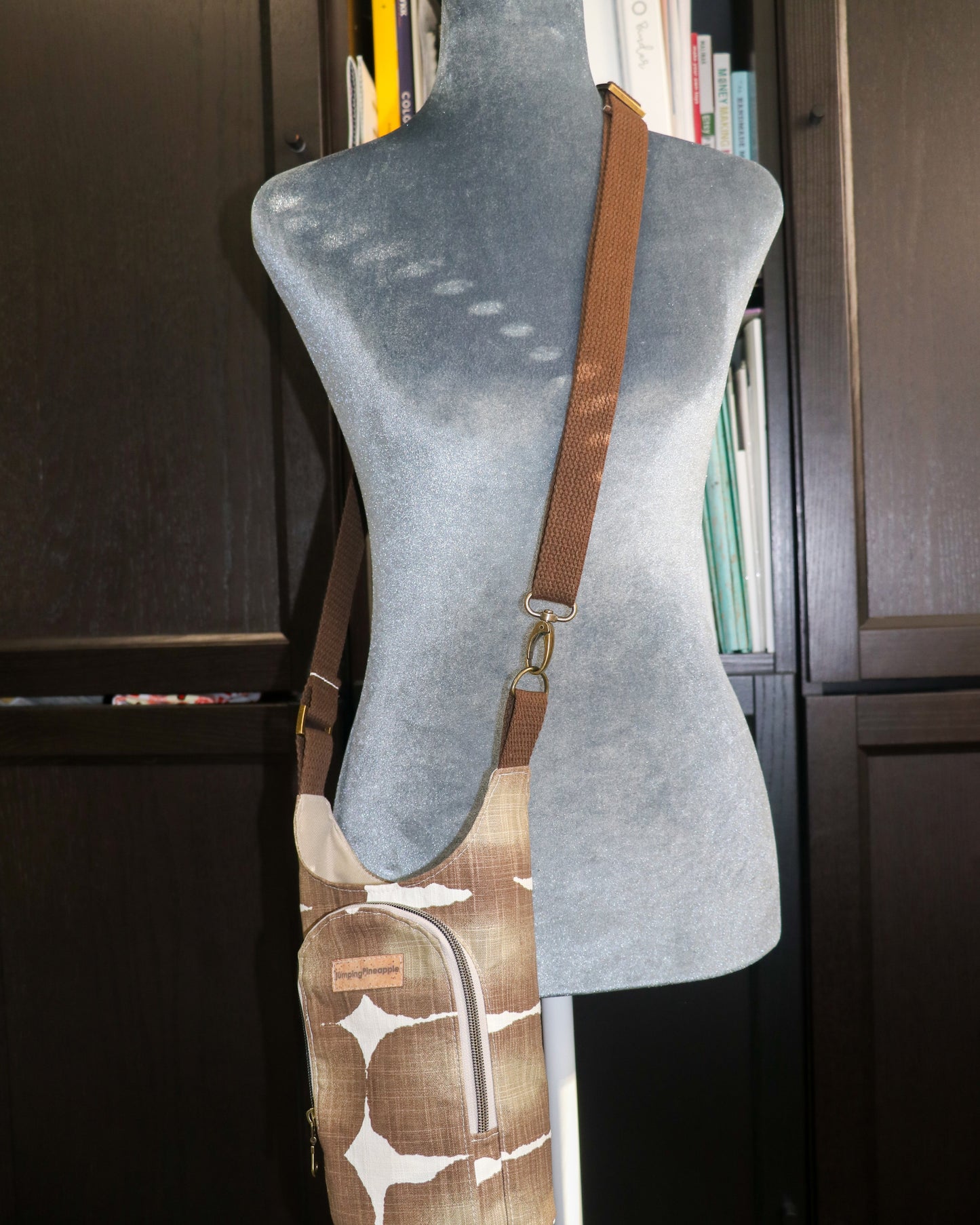 brown shibori print  water bottle sling on a mannequin