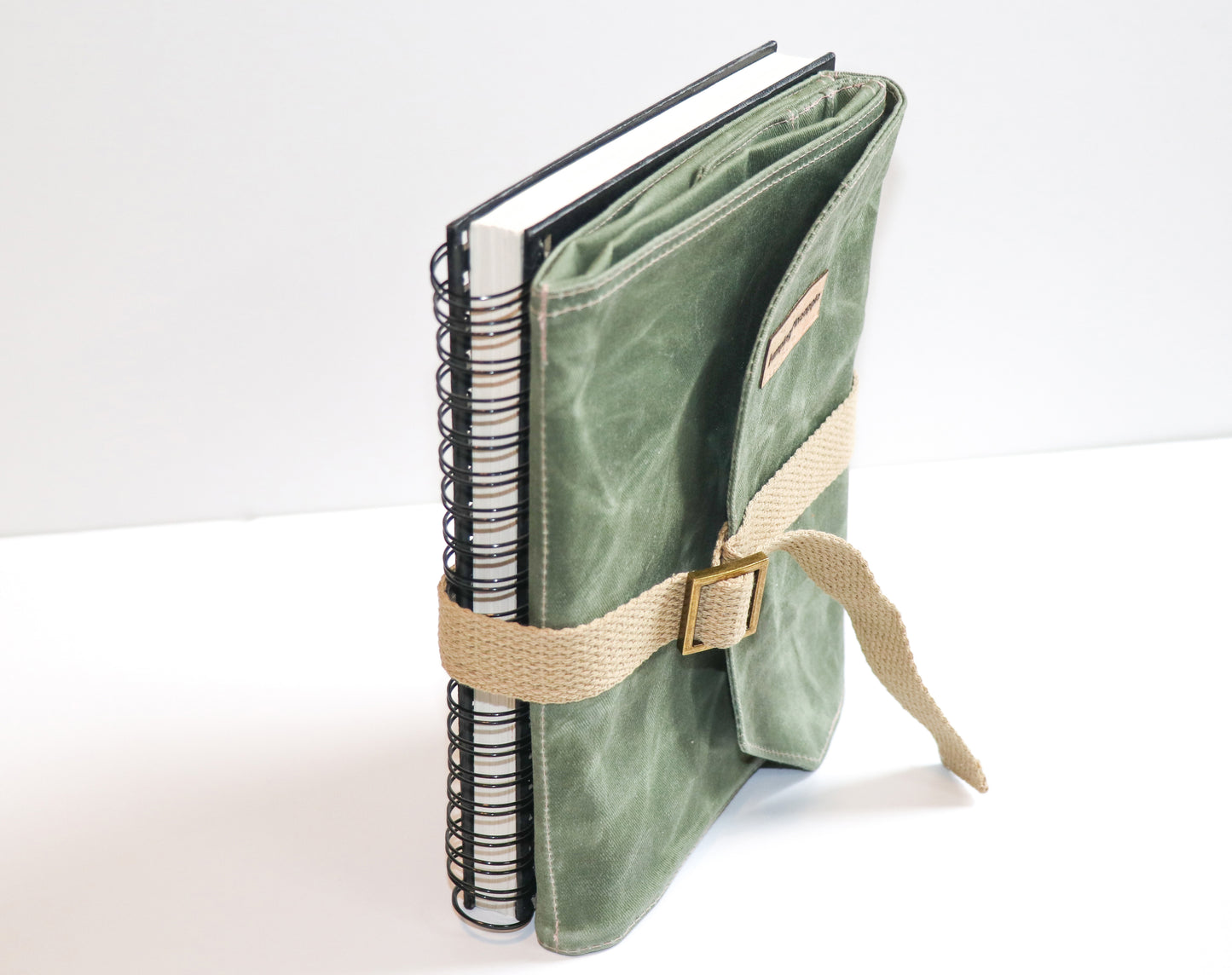 olive waxed canvas artist roll, sketchbook strapped to back