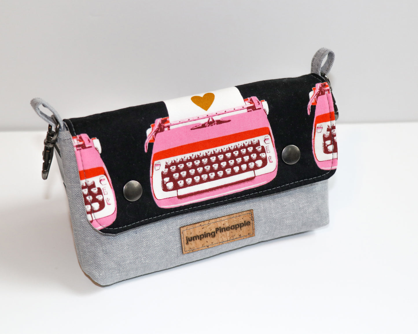 black and pink typewriter belt loop pouch, angled front view