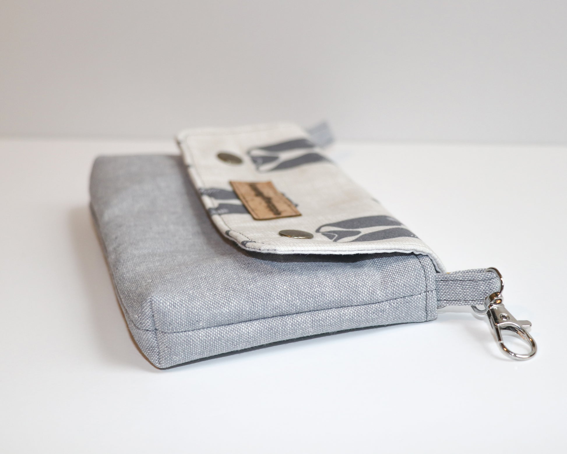 belt loop pouch with dark grey dogs, side view laying flat