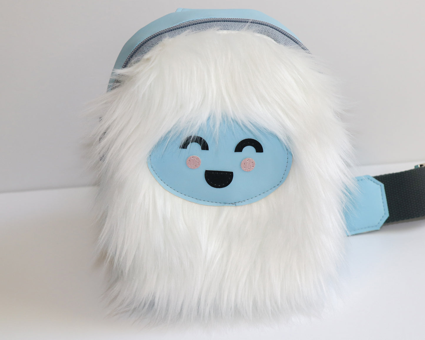 white furry Yeti mini backpack sling, front view