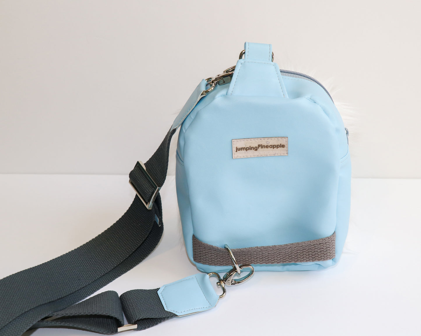 white furry Yeti mini backpack sling, back view