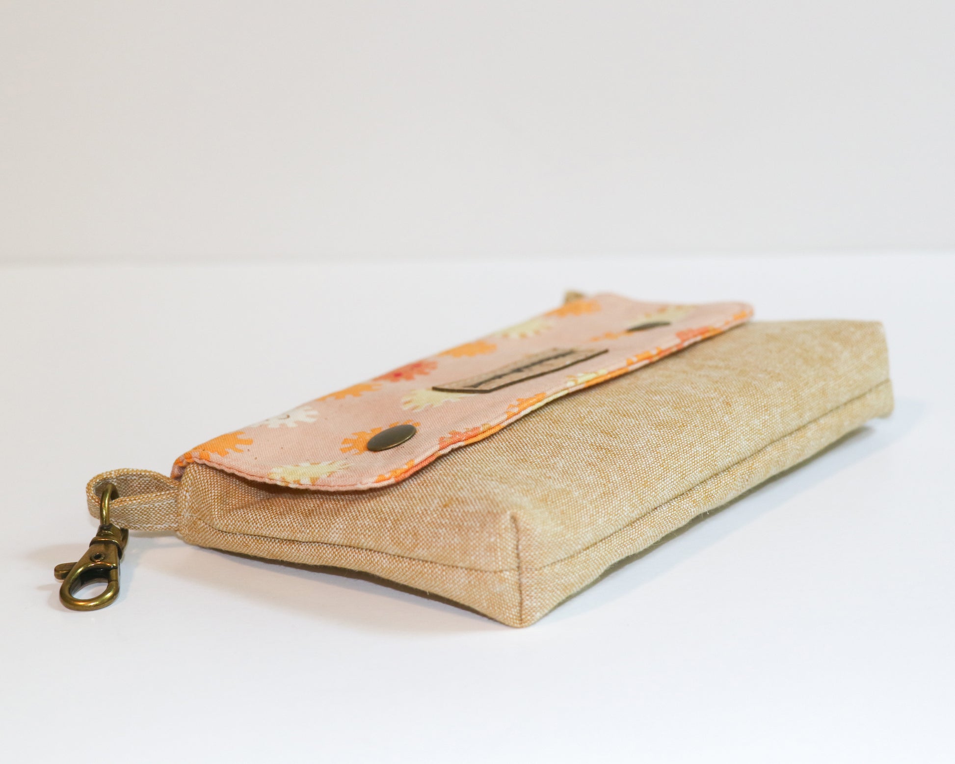 coral sunshine belt loop pouch, laying on side