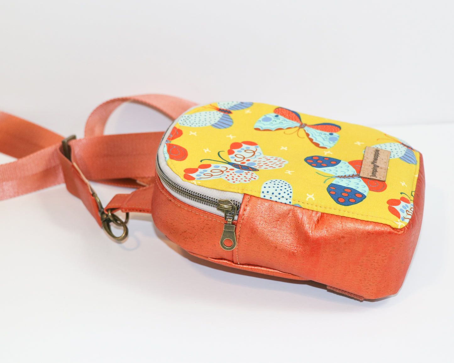 butterflies and shimmer orange cork mini backpack sling, side view
