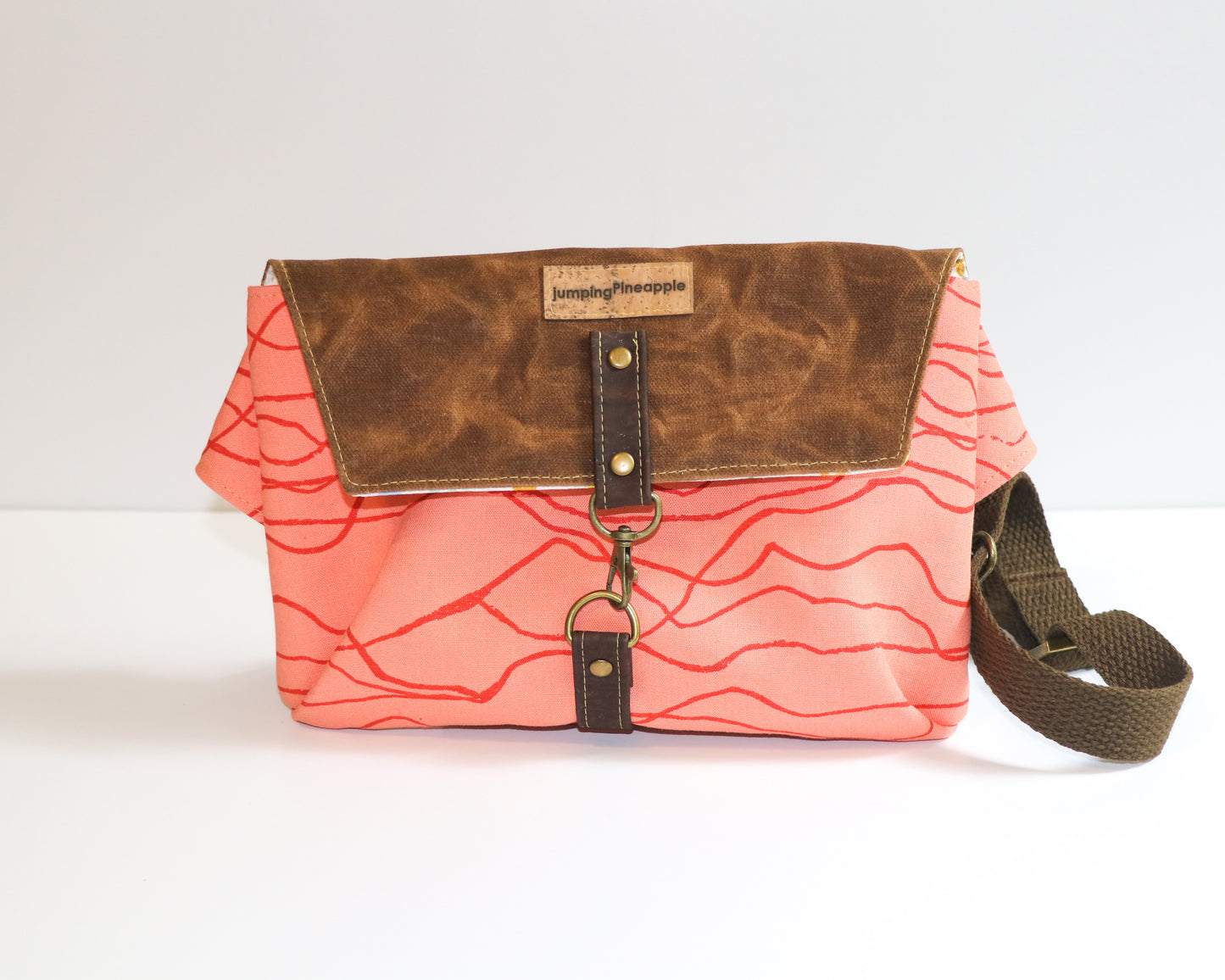 coral canvas with brown waxed canvas flap belt bag, front view