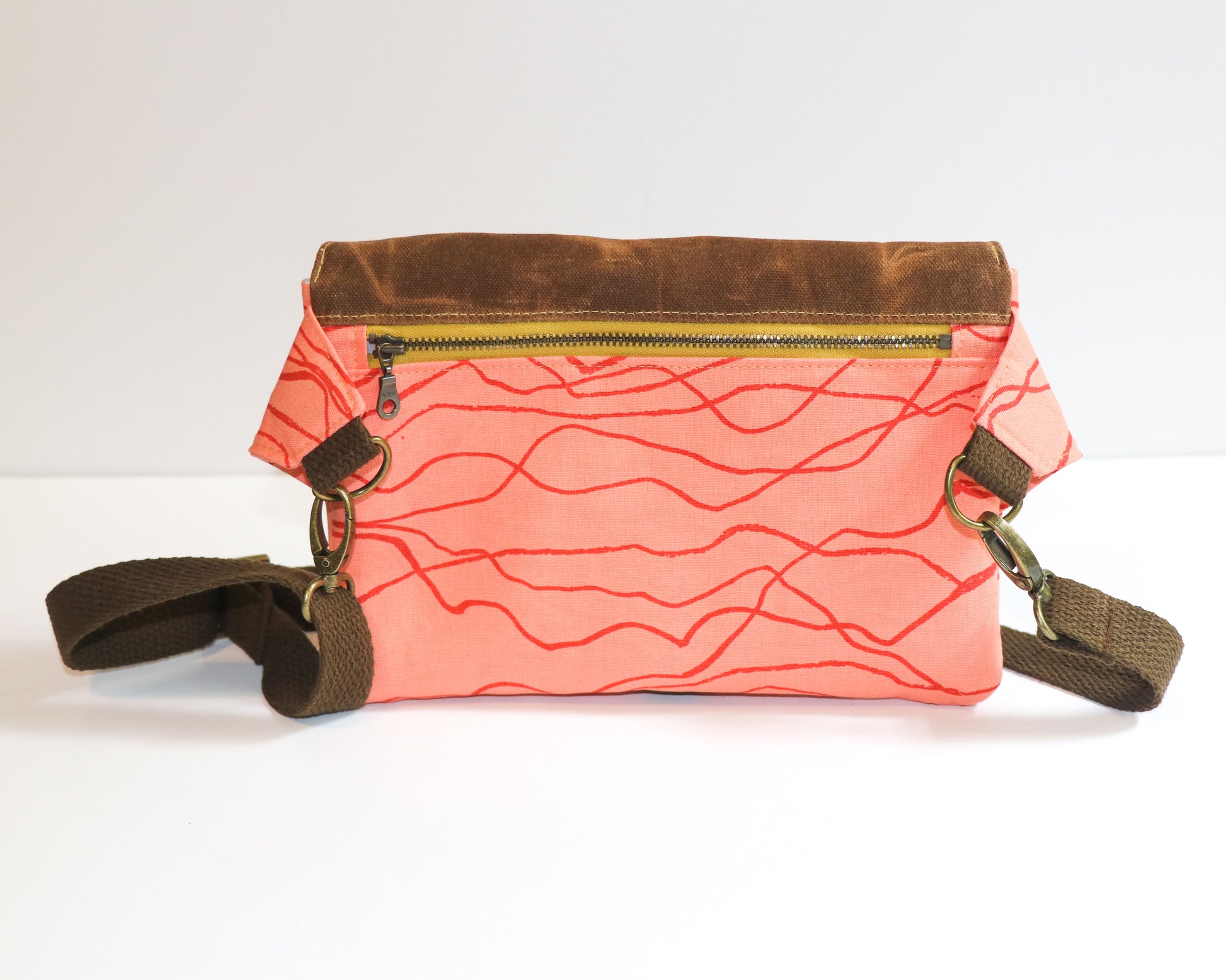 coral canvas with brown waxed canvas flap belt bag, back view