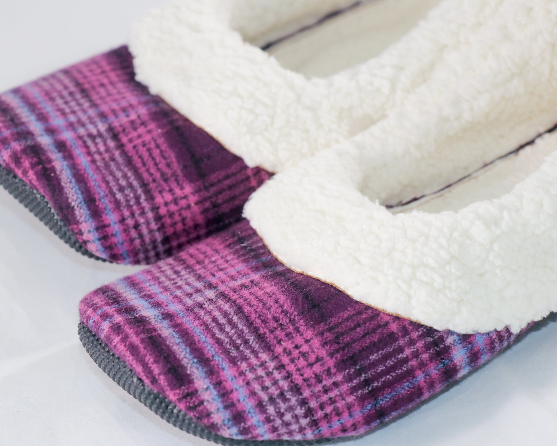 close up of magenta plaid flannel slippers with sherpa lining