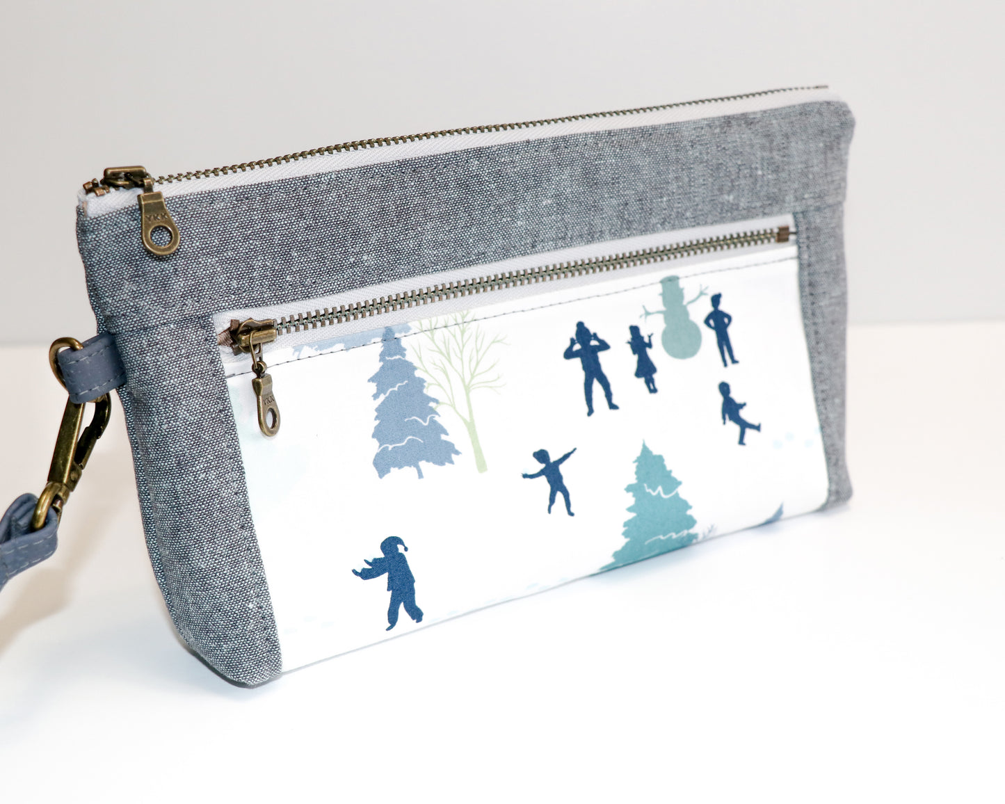 kids playing in the snow and grey/blue linen wristlet